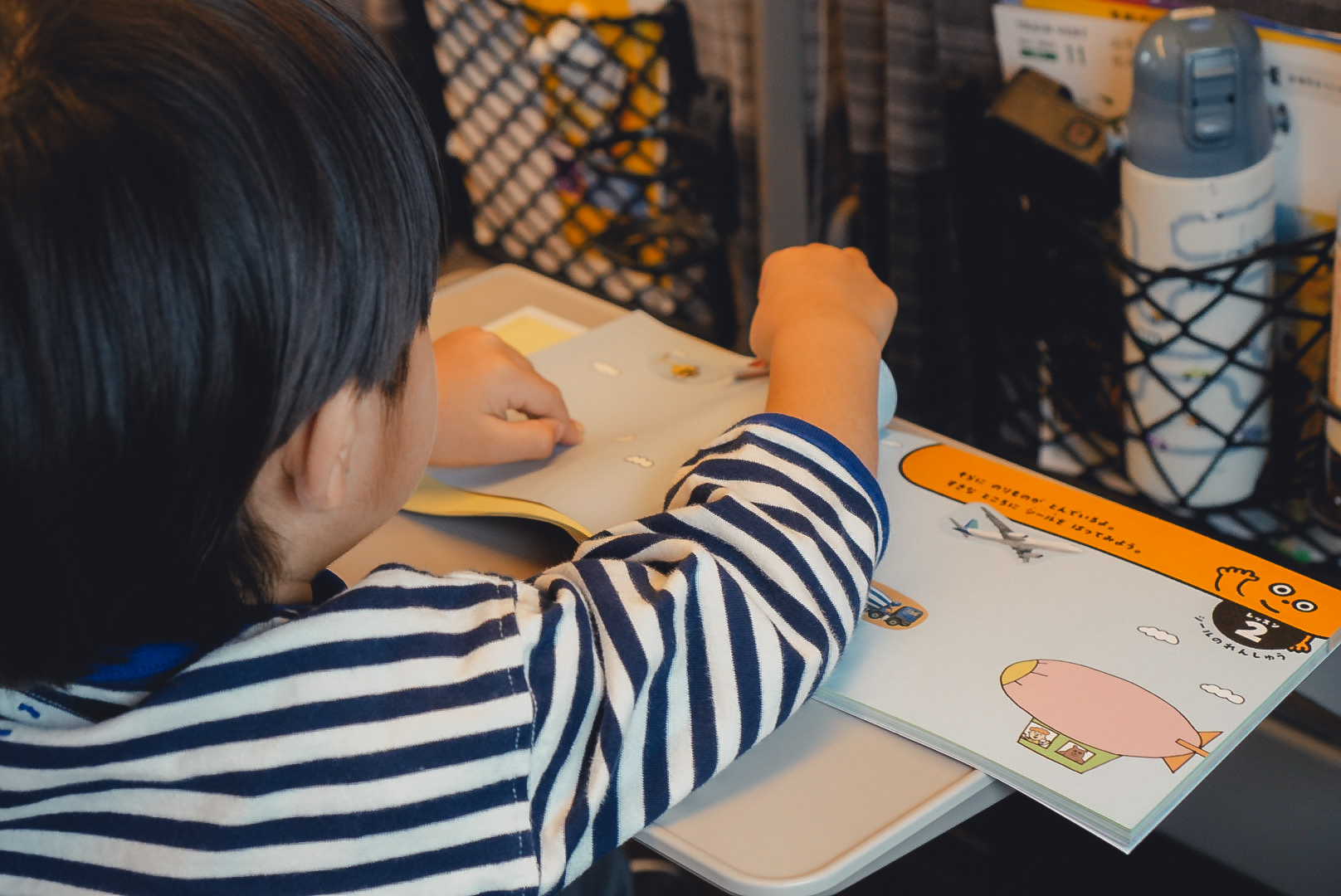 シールブックをする息子の写真